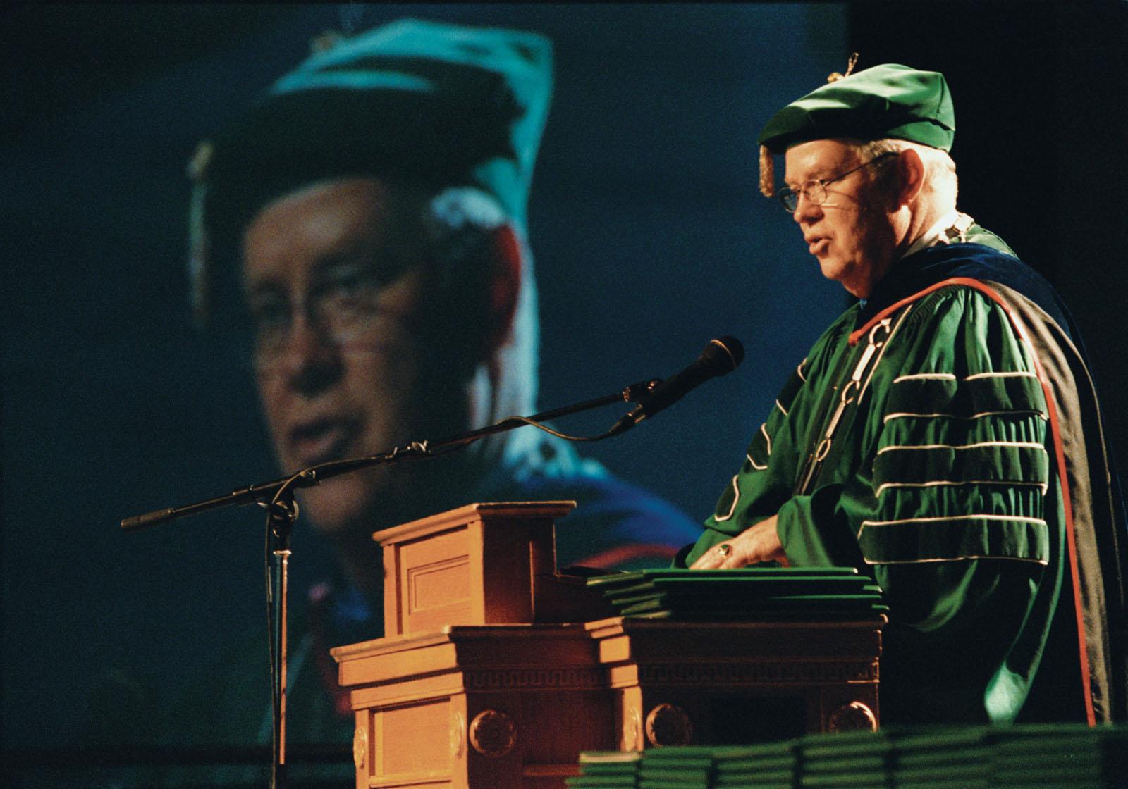 President Hubbard addresses graduates and their families during the December 2000 graduation ceremony in Bearcat Arena.